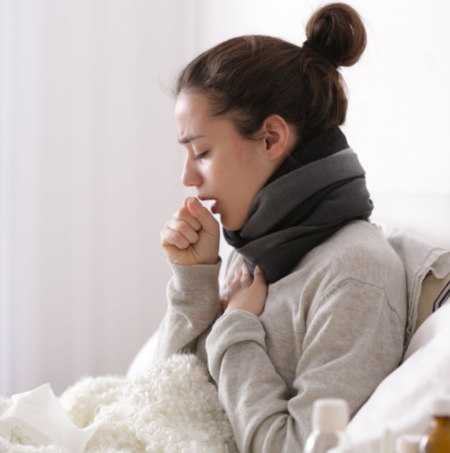 Provider listening to a patient's chest during a cough evaluation at Elon Health Urgent Care in Davenport, FL