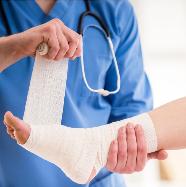 Provider wrapping a patient's sprained ankle at Elon Health Urgent Care in Davenport, FL